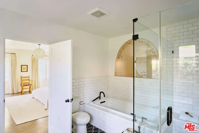 a bedroom with a bed and a wooden floor