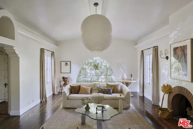 a living room with furniture potted plant and a fireplace