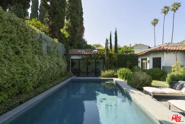 a flower plants in front of yellow house
