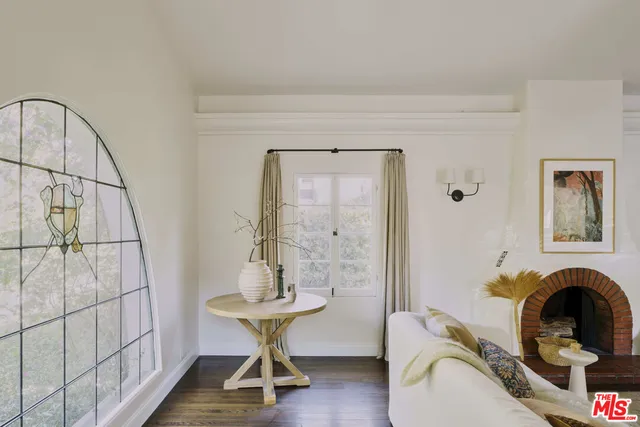 a bedroom with furniture and a wooden floor