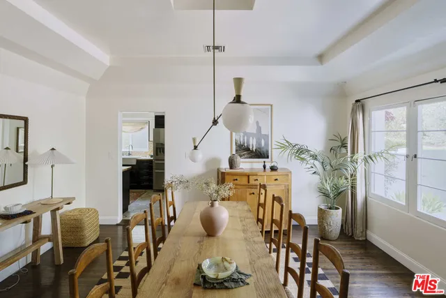 a view of a room with wooden floor and furniture