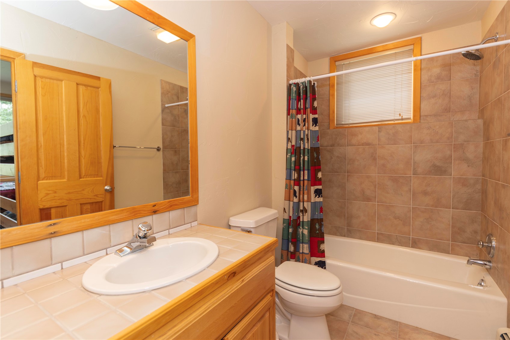 760 Penstemon Road Keystone, CO 80435 - Photo 30 of 39 Full bathroom with tile patterned flooring, shower / bath combo with shower curtain, toilet, and vanity