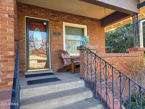 a view of a porch with wooden floor and iron stairs