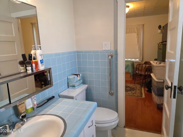 a bathroom with a toilet sink and mirror