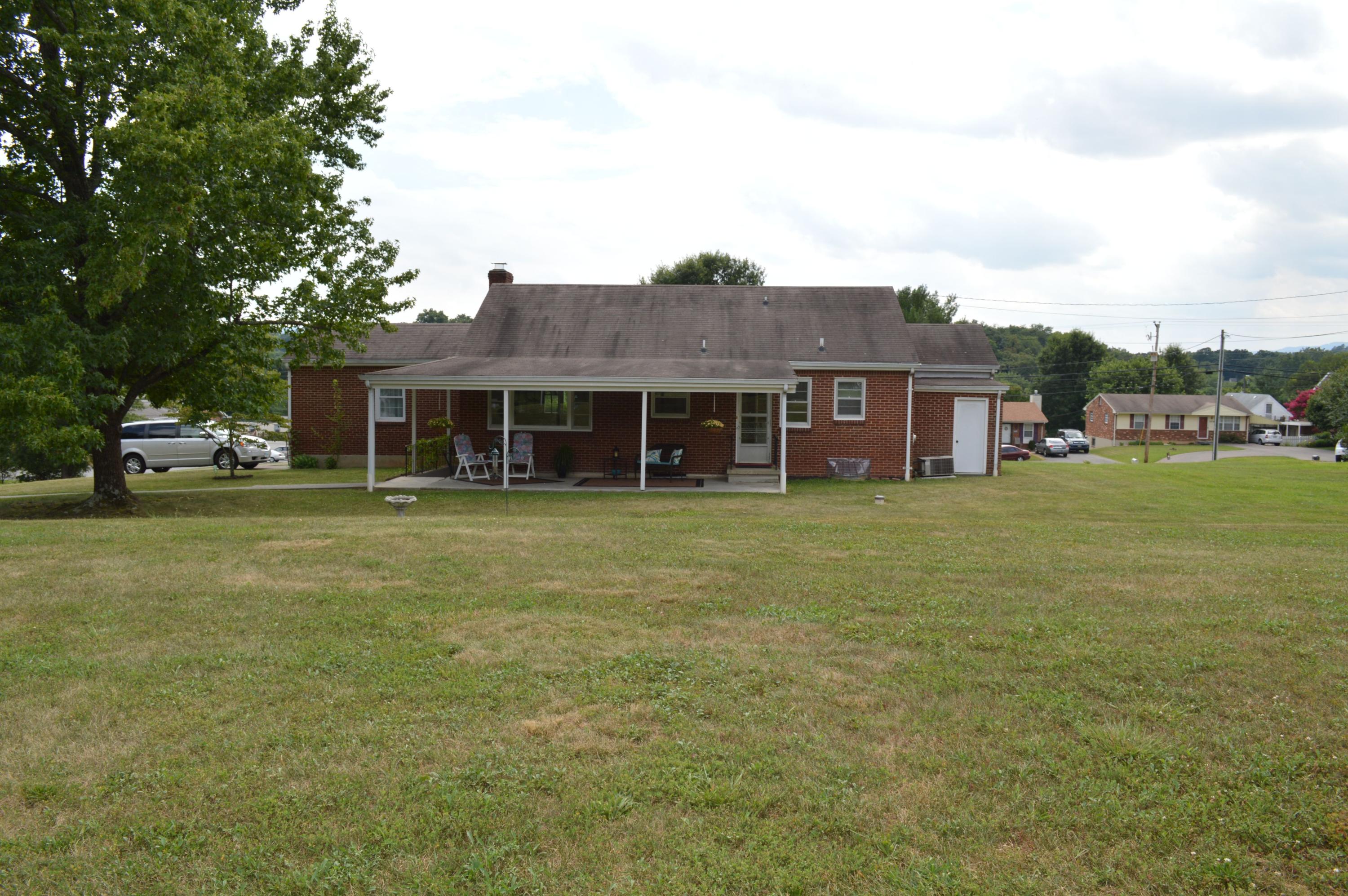 5527 Cove Road Roanoke, VA 24019 - Photo 12 of 39 a front view of a house with a garden and trees