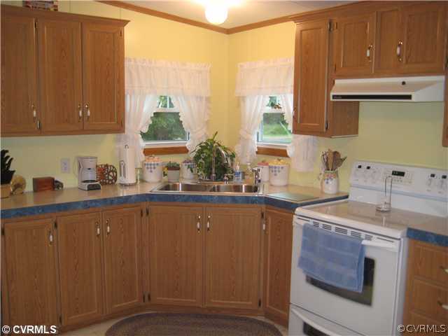 1222 Bible Road Crewe, VA 23930 - Photo 6 of 12 a kitchen with a sink cabinets and window
