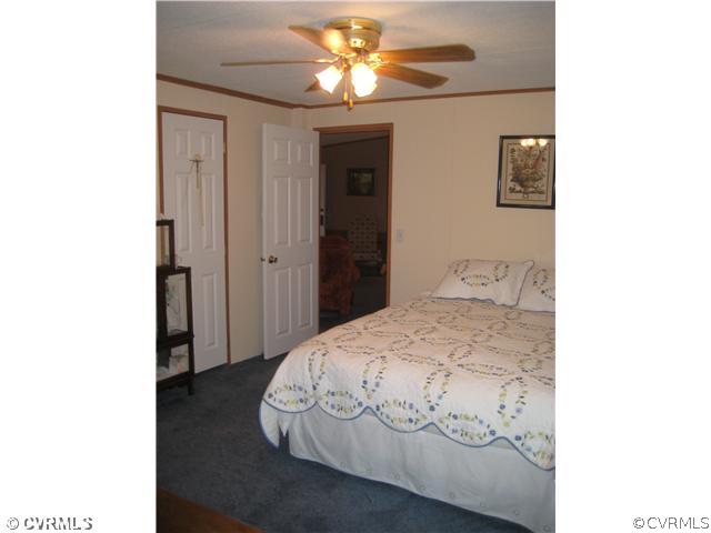 1222 Bible Road Crewe, VA 23930 - Photo 8 of 12 a bedroom with a bed and a chandelier