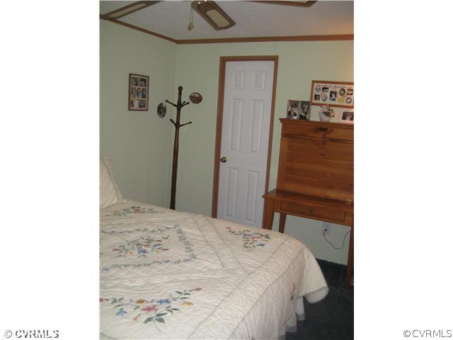 1222 Bible Road Crewe, VA 23930 - Photo 9 of 12 a bedroom with a bed and a cabinets