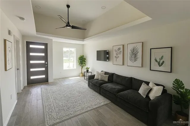 a living room with furniture and wooden floor