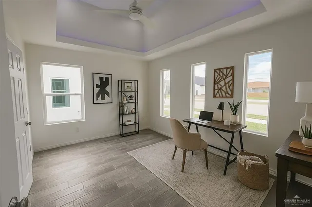 a view of a livingroom with workspace and a window