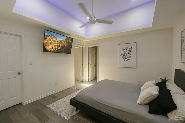 a bedroom with a bed and a wall painting