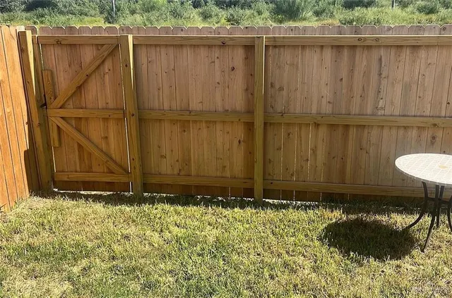 a view of outdoor space with wooden fence
