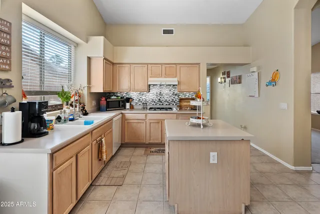 a kitchen with a sink stove top oven and cabinets