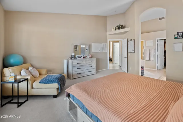 a bedroom with a bed and a couch