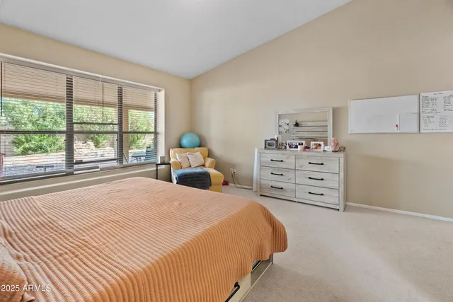 a bedroom with a bed and a large window
