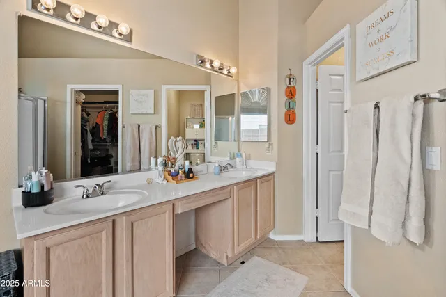 a bathroom with a double vanity sink and mirror