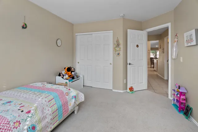 a bedroom with a bed and a dresser