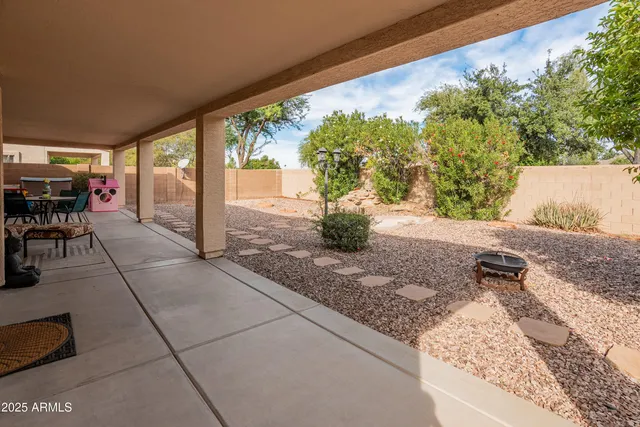 a view of backyard with patio
