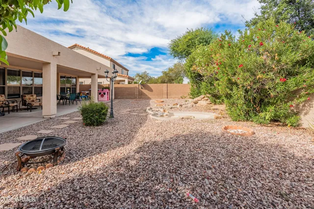 a view of a backyard space with a large tree