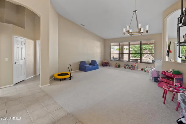 a dining room with furniture and a chandelier