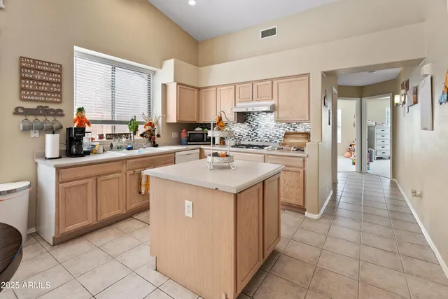 a kitchen with a sink stove and cabinets
