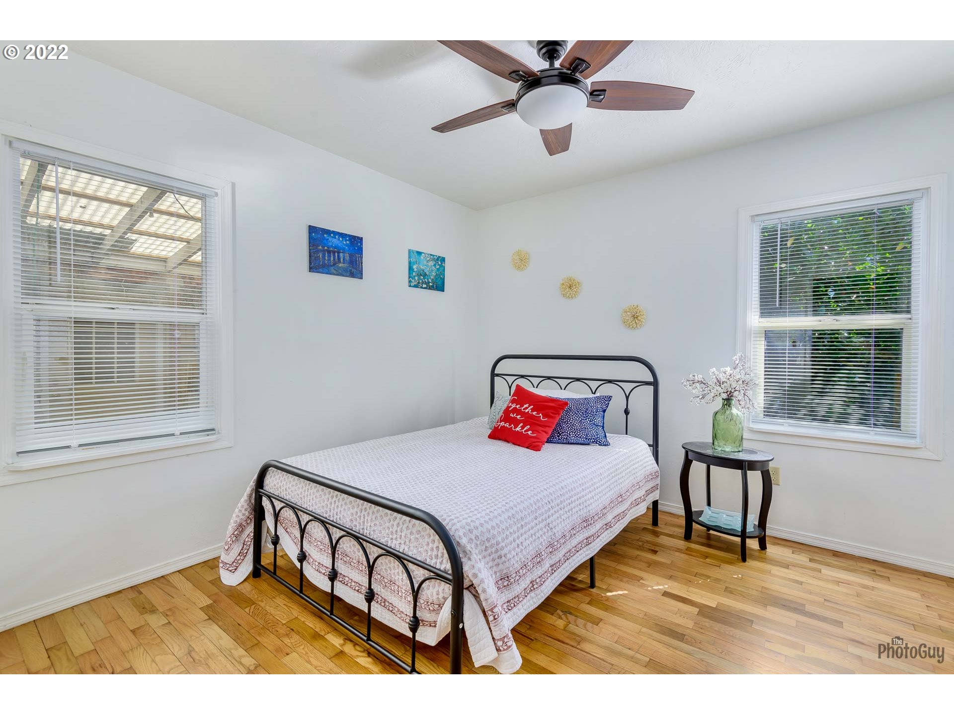 3268 Oregon Avenue Springfield, OR 97478 - Photo 11 of 32 a bedroom with a bed a window and a chandelier