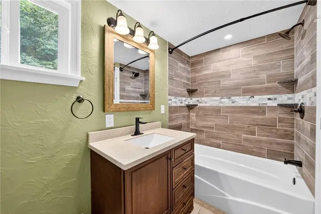 a view of a room with wooden floor and ceiling fan