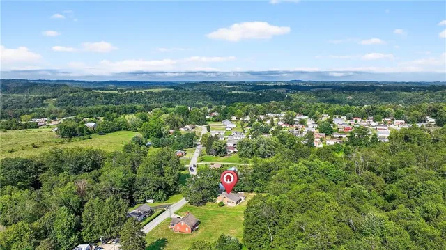 a view of a city with lush green forest