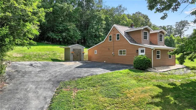 a house view with a trees in front of it