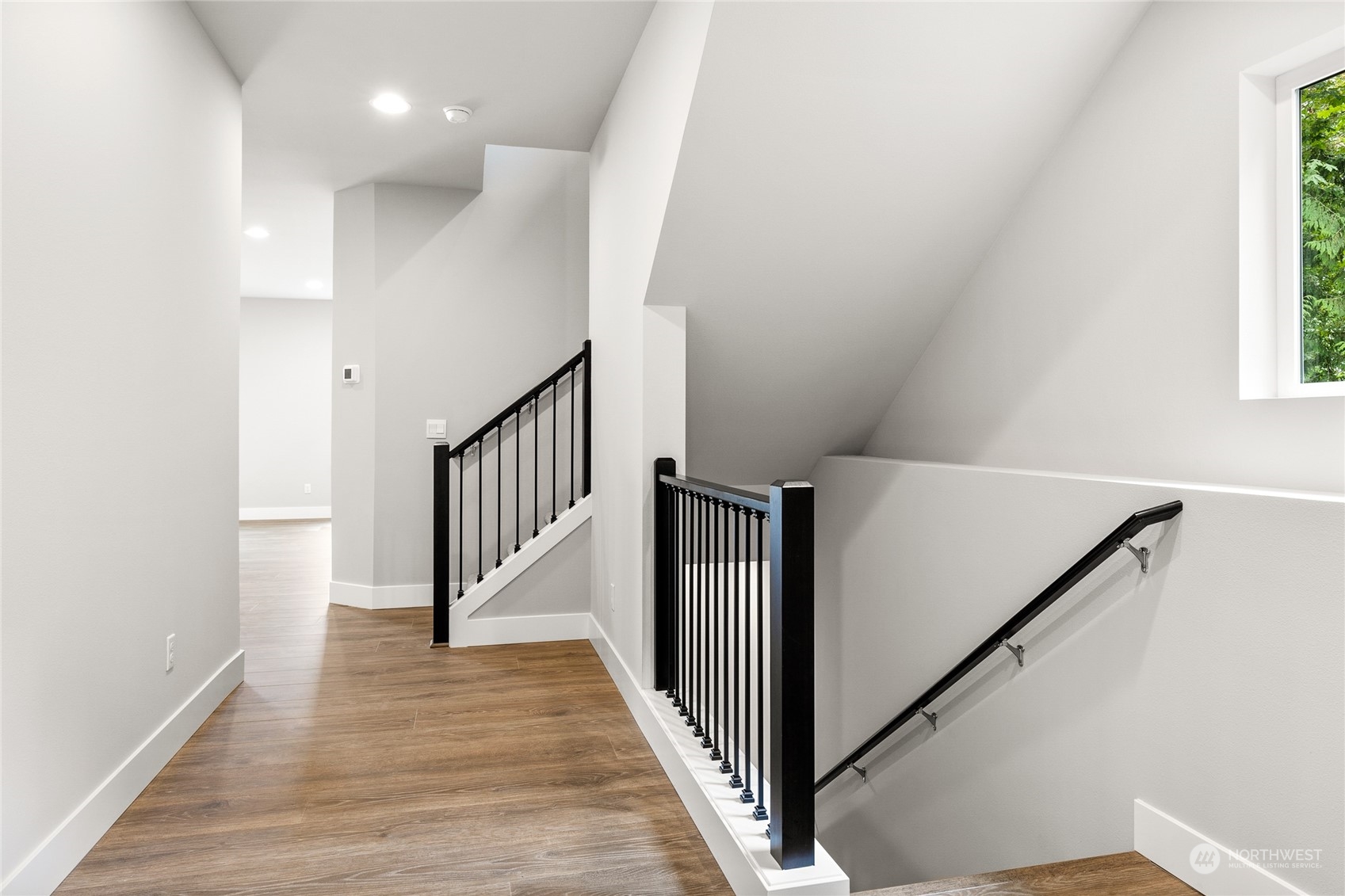 17 178th Place Southwest Bothell, WA 98012 - Photo 22 of 32 a view of a hallway with wooden floor and staircase