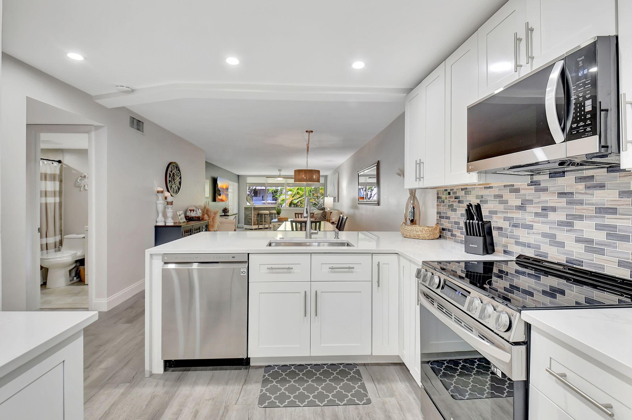 a kitchen with stainless steel appliances granite countertop a sink and a stove