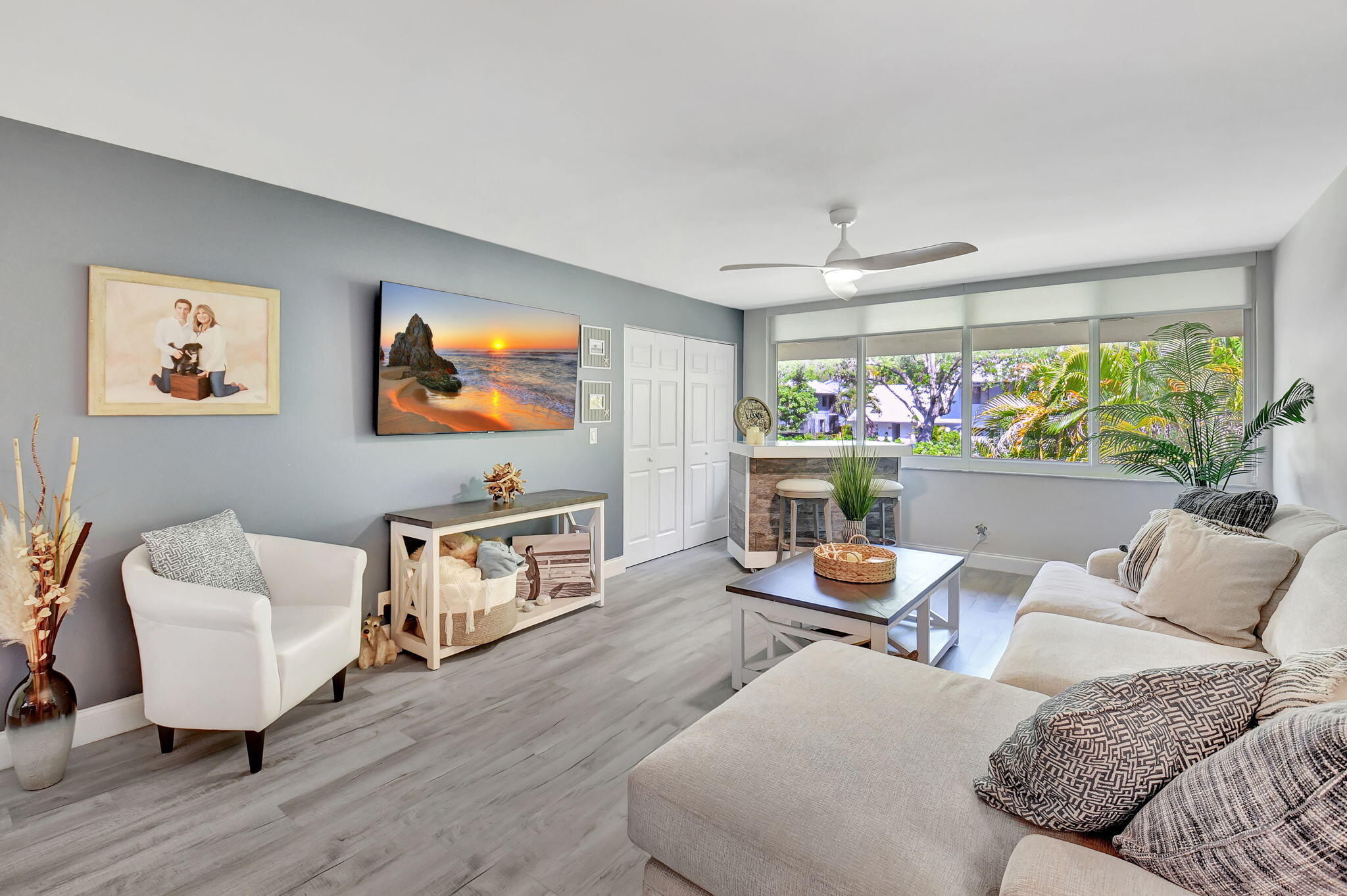 2805 Southwest 22nd Avenue, Unit 2050 Delray Beach, FL 33445 - Photo 11 of 36 a living room with furniture and a flat screen tv