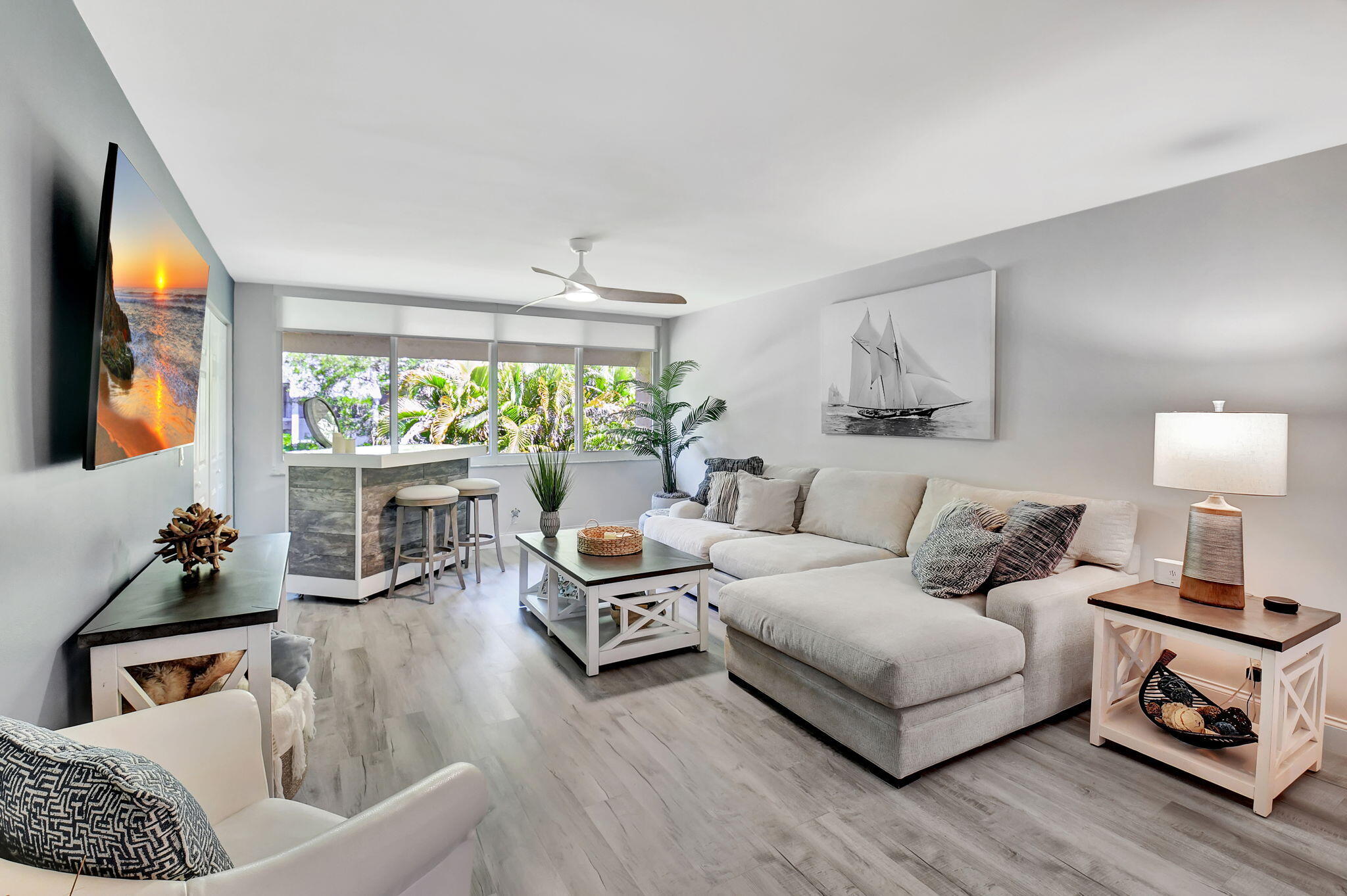 2805 Southwest 22nd Avenue, Unit 2050 Delray Beach, FL 33445 - Photo 13 of 36 a living room with furniture and a large window