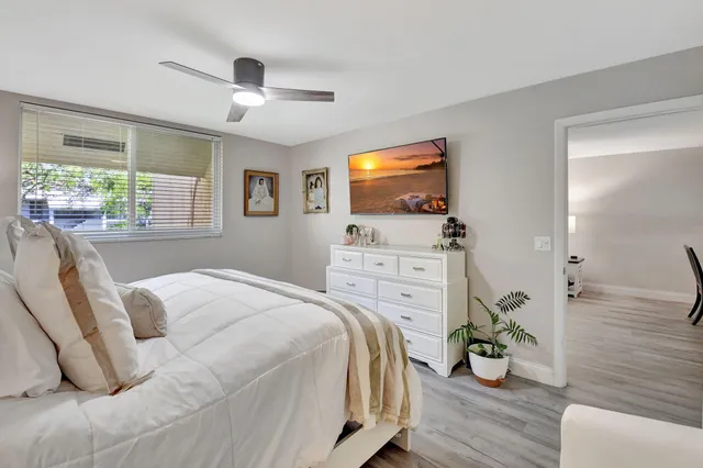 a bathroom with a sink toilet a mirror and shower
