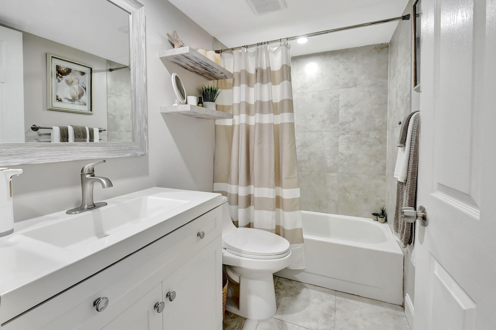 2805 Southwest 22nd Avenue, Unit 2050 Delray Beach, FL 33445 - Photo 18 of 36 a bathroom with a sink toilet and shower