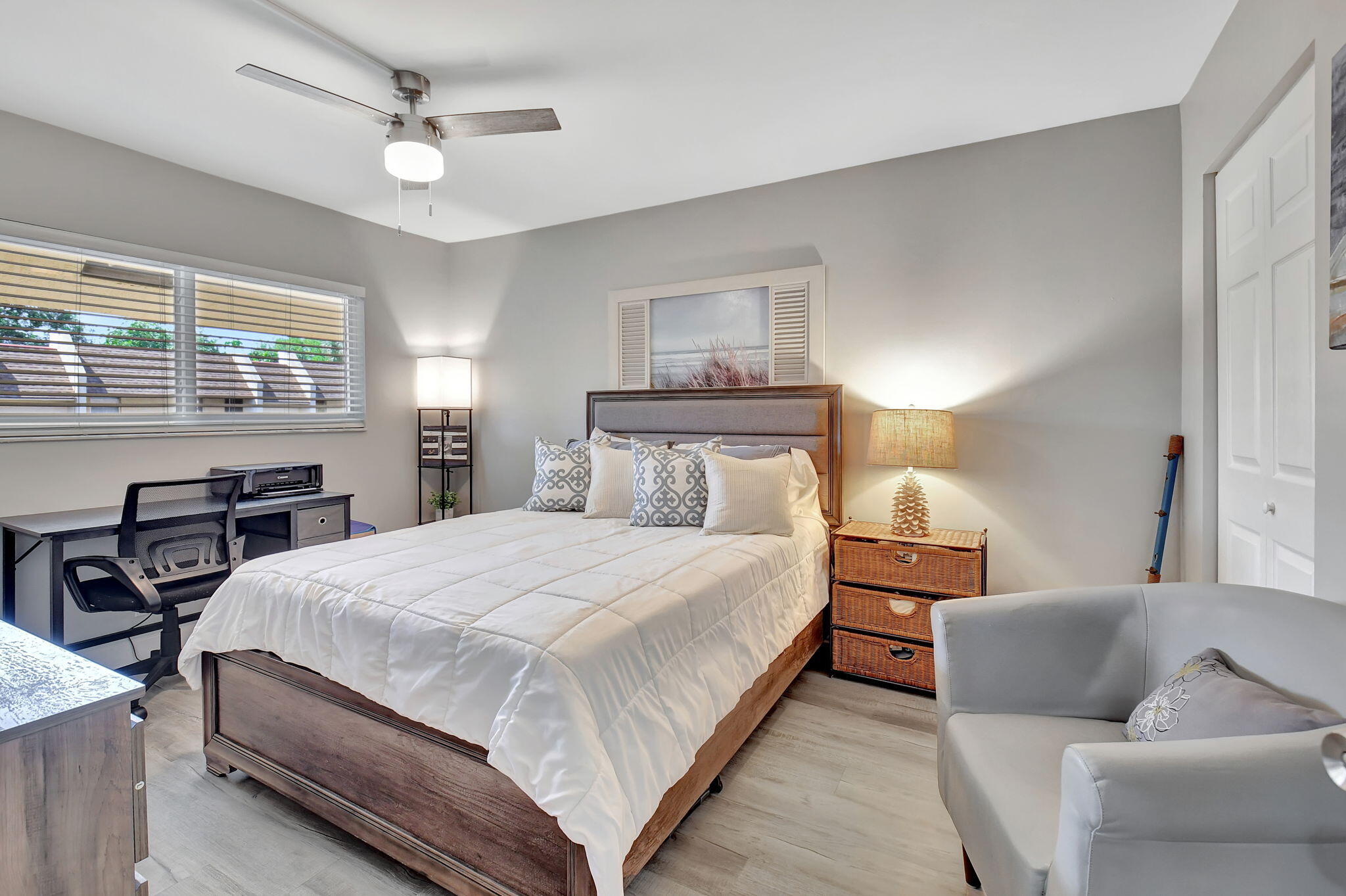 2805 Southwest 22nd Avenue, Unit 2050 Delray Beach, FL 33445 - Photo 19 of 36 a bedroom with a bed and wooden floor