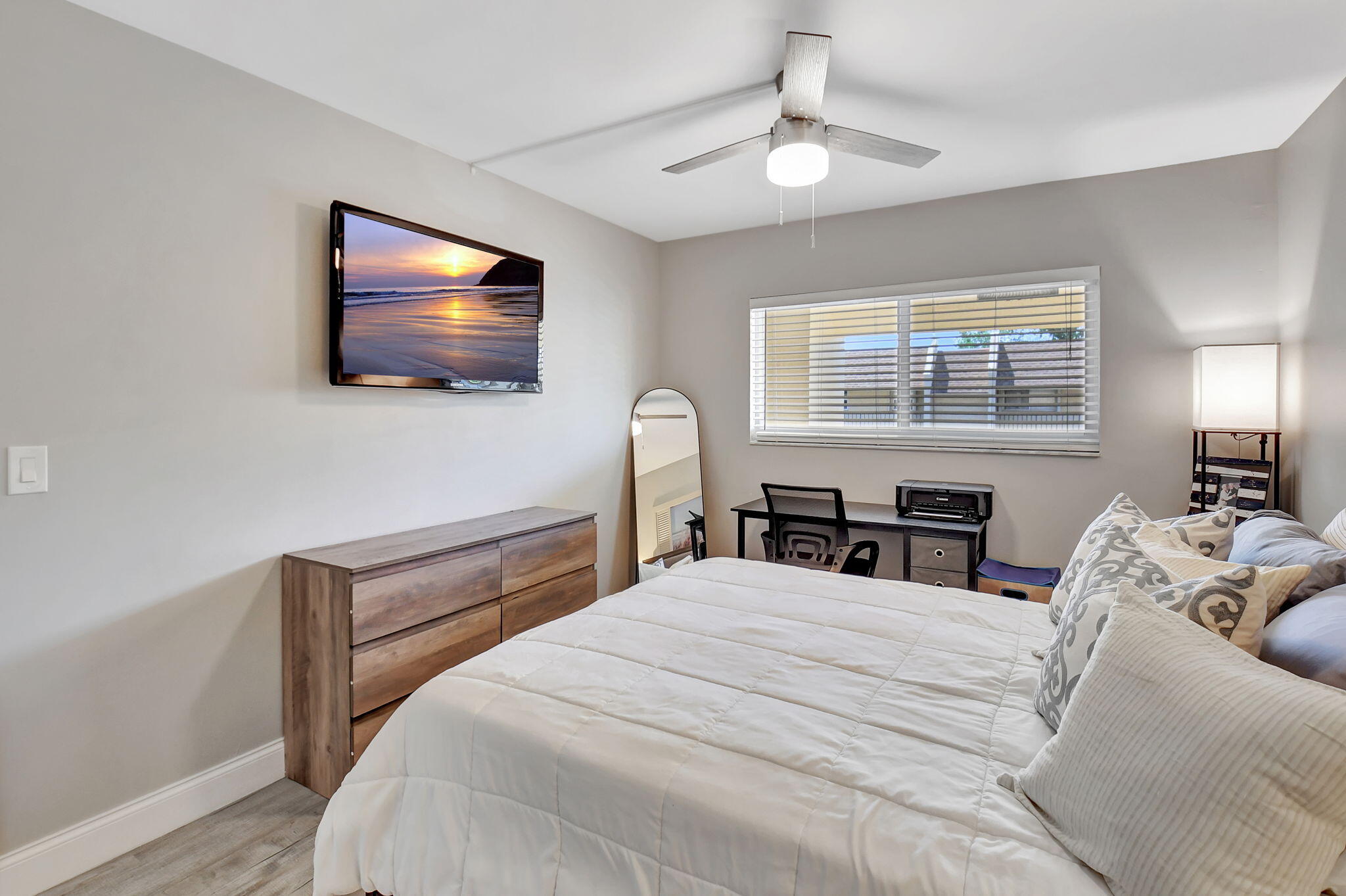 2805 Southwest 22nd Avenue, Unit 2050 Delray Beach, FL 33445 - Photo 20 of 36 a bedroom with a bed and a flat screen tv