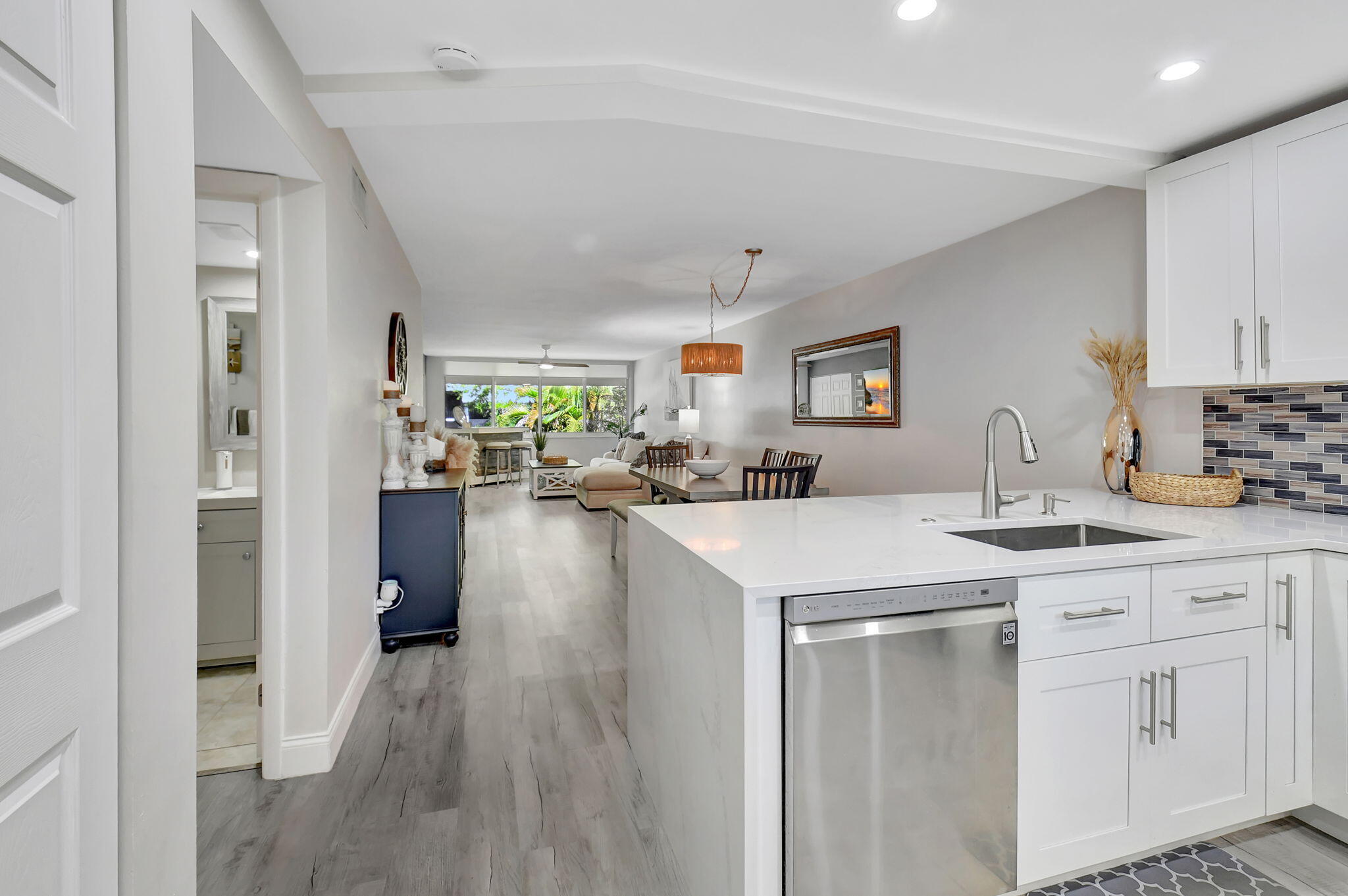 2805 Southwest 22nd Avenue, Unit 2050 Delray Beach, FL 33445 - Photo 2 of 36 a kitchen with white cabinets appliances and a window
