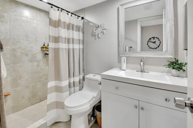 a bathroom with a shower curtain and a shower