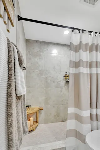 an aerial view of residential houses with outdoor space and trees