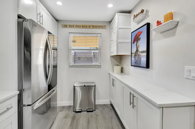 a kitchen with stainless steel appliances a refrigerator and a sink