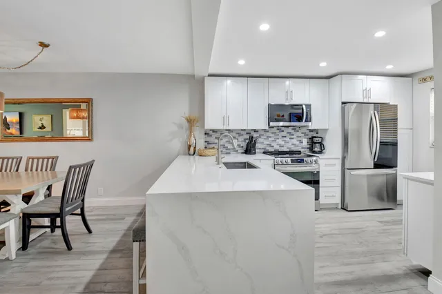 a kitchen with stainless steel appliances a refrigerator stove microwave and cabinets