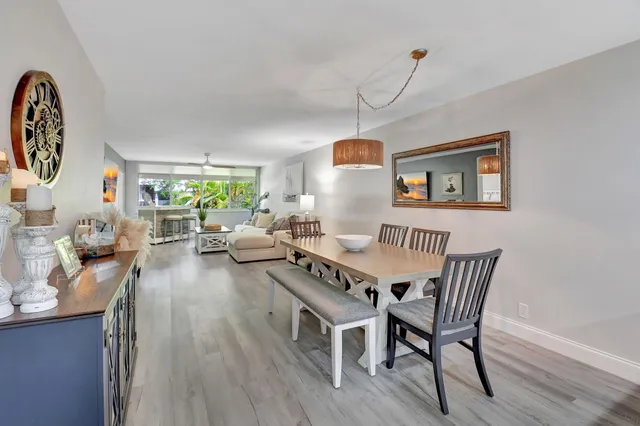 a view of a dining room with furniture a chandelier and wooden floor