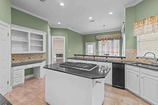 a kitchen with stainless steel appliances granite countertop a refrigerator and a stove top oven
