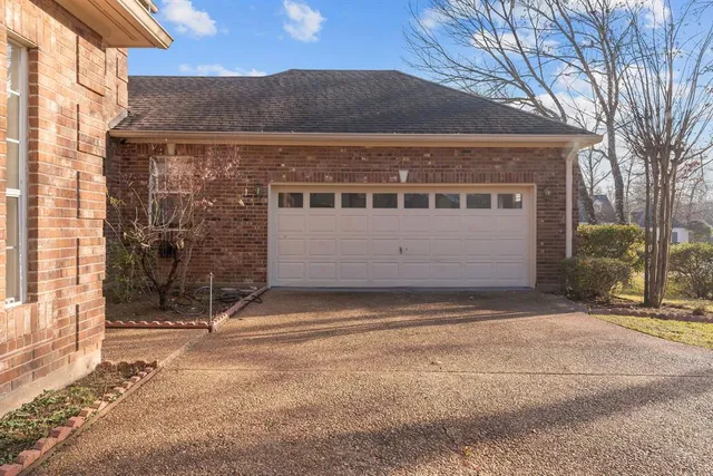 a view of house with backyard
