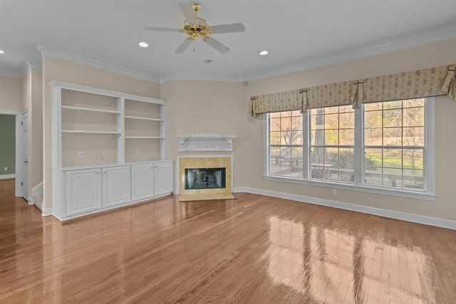 wooden floor chandelier and windows in a room