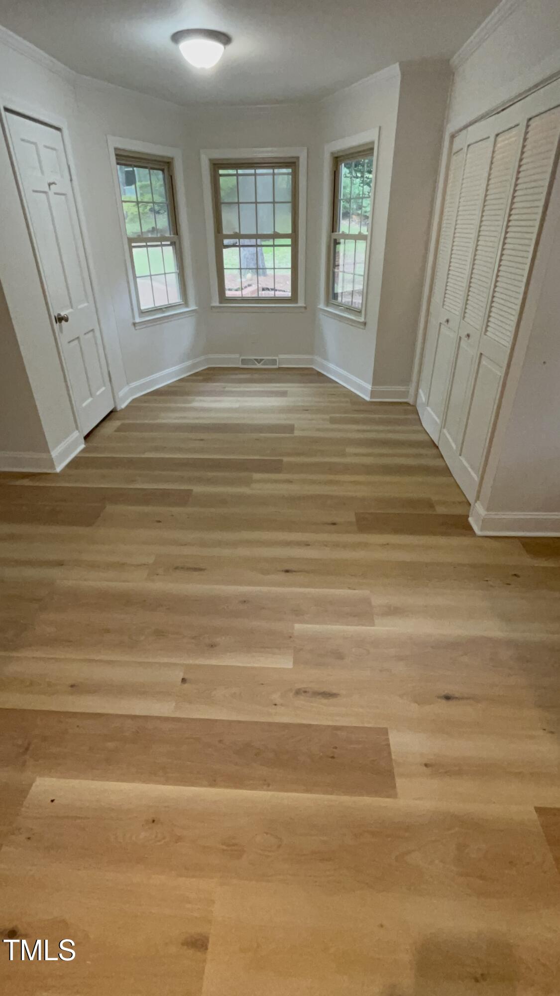 120 Dundee Road Fayetteville, NC 28303 - Photo 17 of 32 a view of an empty room with window and wooden floor
