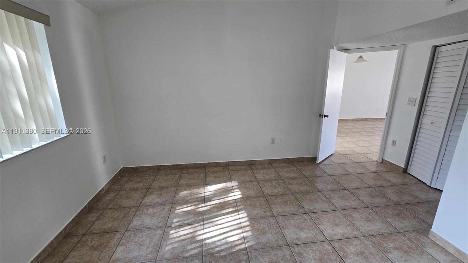 13120 Southwest 64th Terrace, Unit 1510 Miami, FL 33183 - Photo 13 of 25 a view of an empty room and a window