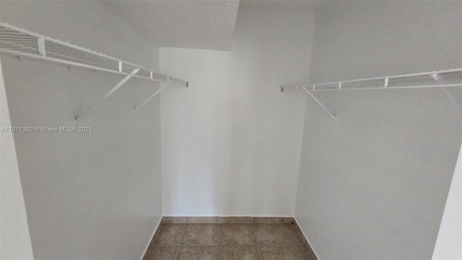 13120 Southwest 64th Terrace, Unit 1510 Miami, FL 33183 - Photo 15 of 24 a view of an empty walk in closet