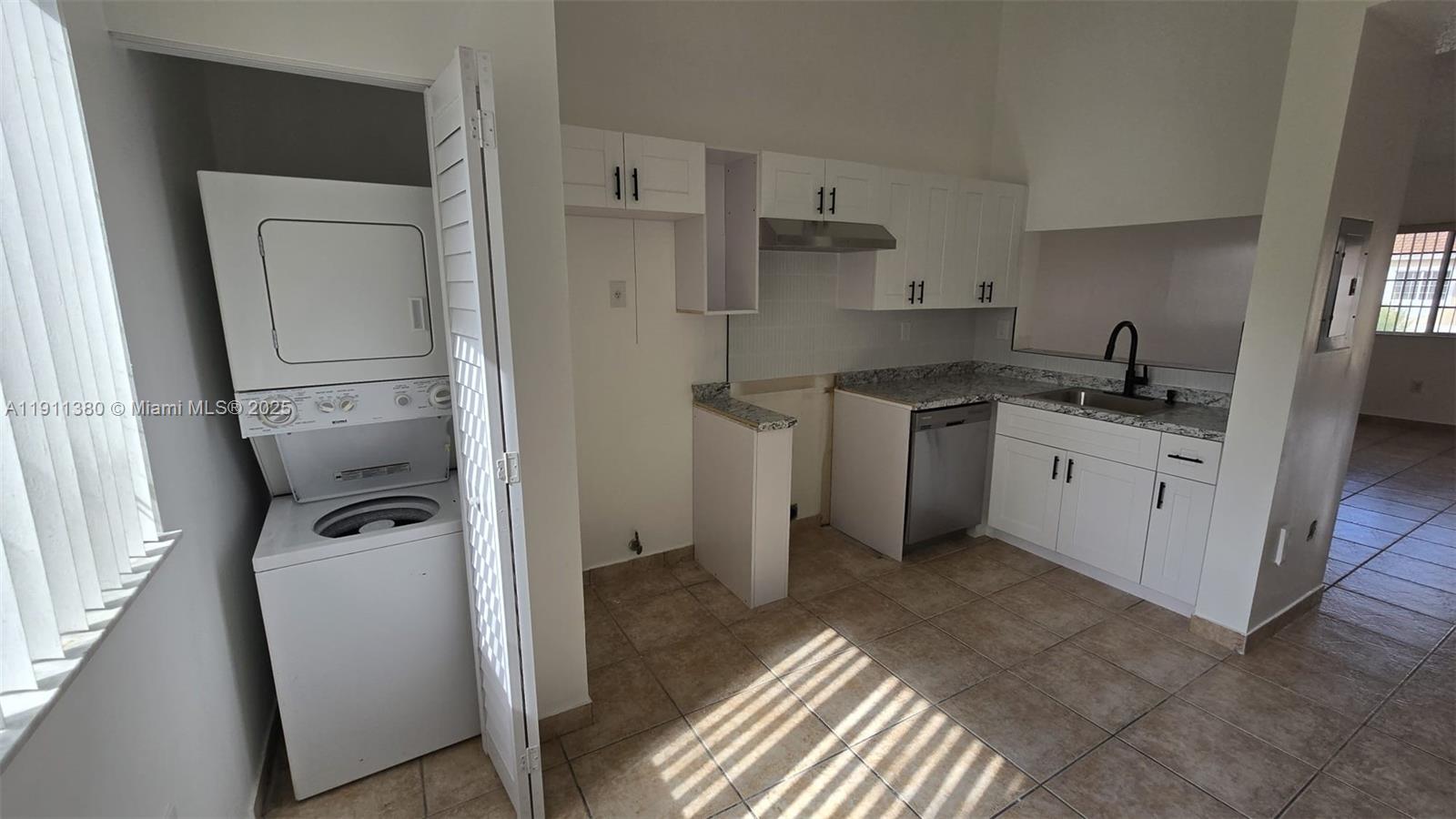 13120 Southwest 64th Terrace, Unit 1510 Miami, FL 33183 - Photo 20 of 24 a kitchen with a sink a stove and refrigerator